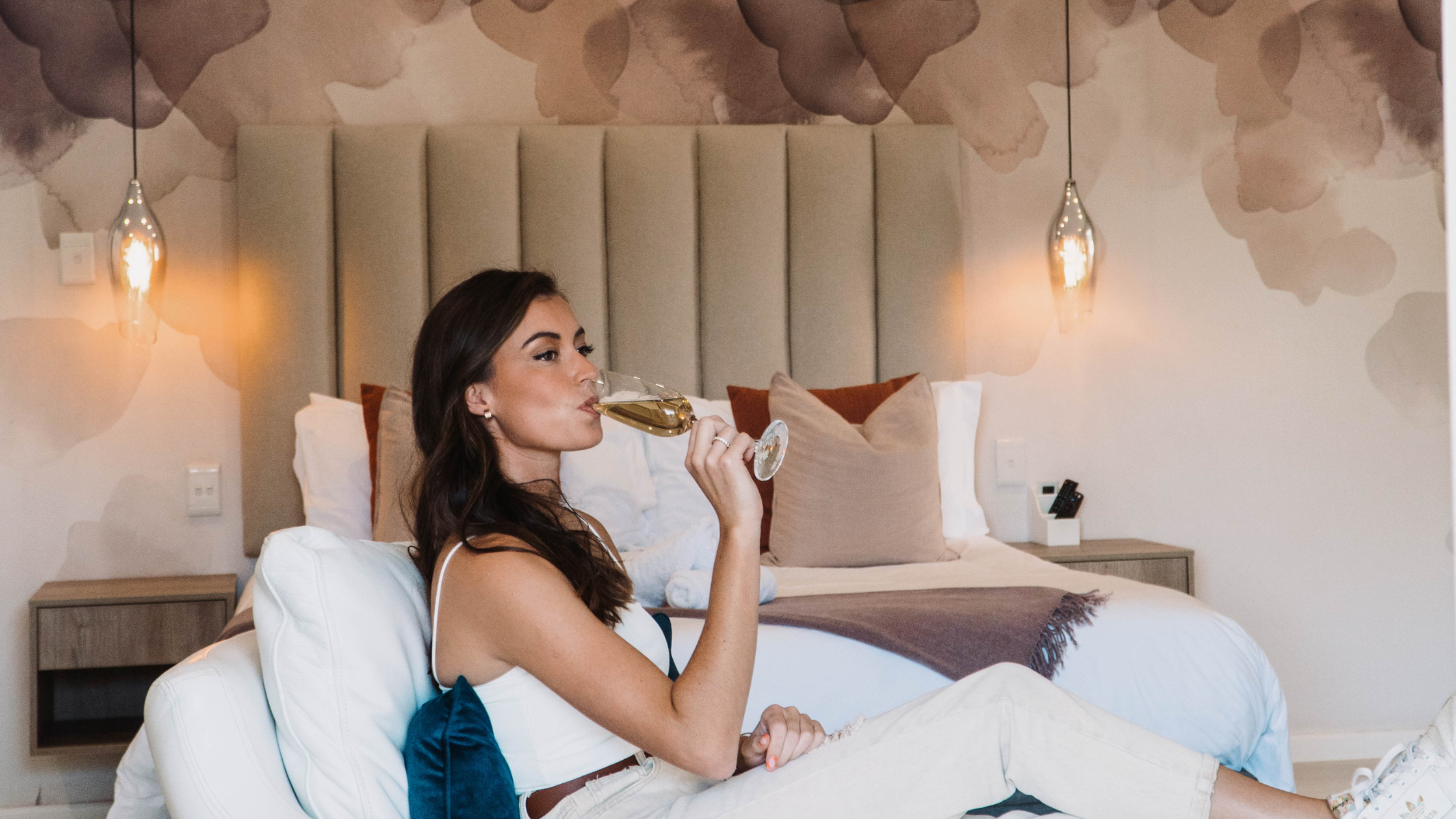 Image of woman drinking wine in a luxury boutique hotel suite at the Salene in Stellenbosch